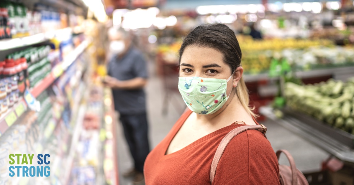 Woman in grocery store wearing mask graphic